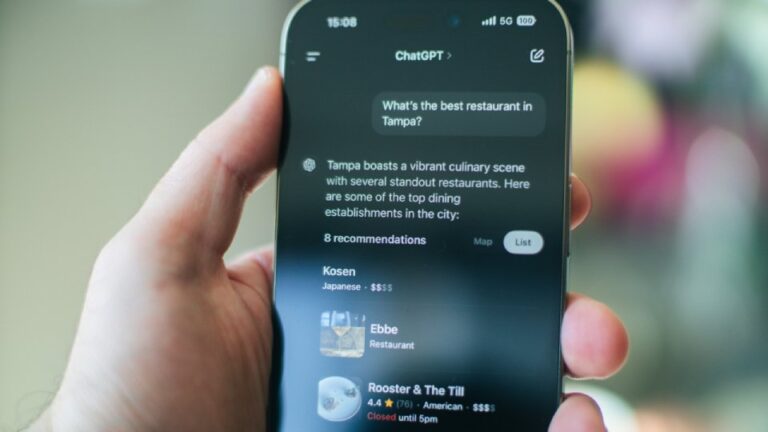 A hand holding a phone asking ChatGPT for restaurant recommendations