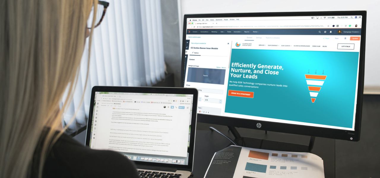Woman working on website structure on two screens and paper
