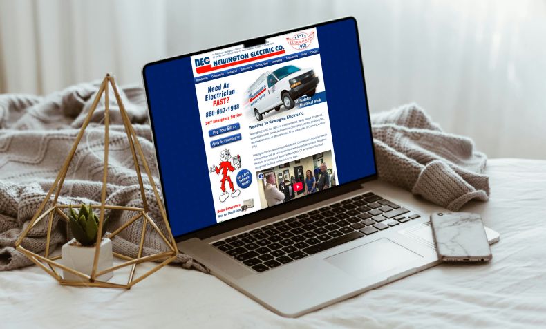 Laptop on bed with old electric companies outdated website