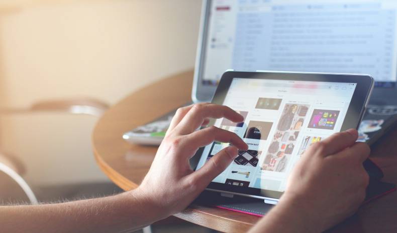 Hands on a touch screen interacting with a website