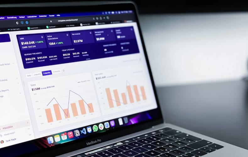 Laptop with business metrics on screen
