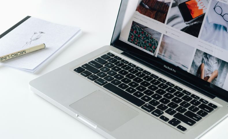 laptop and notepad planning website content
